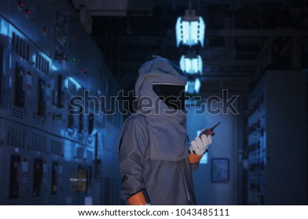 Engineer wear a arc flash protection suit for inspection electrical current 
 and checking status switch gear electrical energy distribution substation. Royalty-Free Stock Photo #1043485111