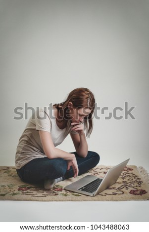 Studio portrait of young writer/blogger/freelancer/student with laptop