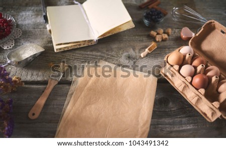Food flat lay on kitchen table background. Flour, eggs, sugar, berries, pastry or bakery cooking. Top view