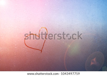 Draw a heart on the mirror with water drops and vintage use a background image to show the love. Royalty-Free Stock Photo #1043497759