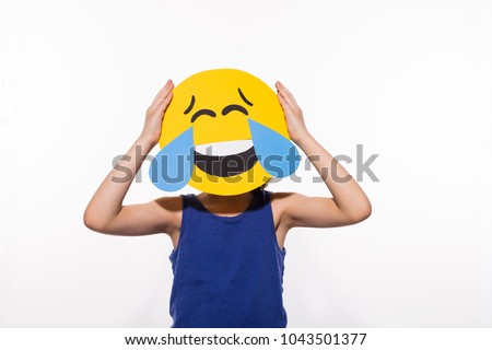 Boy with funny loud laughing emoji head, face with tears of joy, LOL Royalty-Free Stock Photo #1043501377