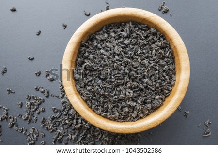 black tea leaves in a wooden bowl