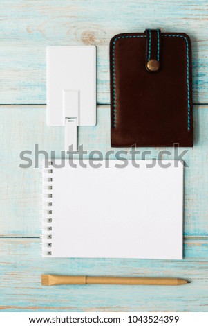 Photo of blank stationery set on wood background. Envelope, business cards, pencil, and A4 paper. Corporate identity template. Responsive design mockup.