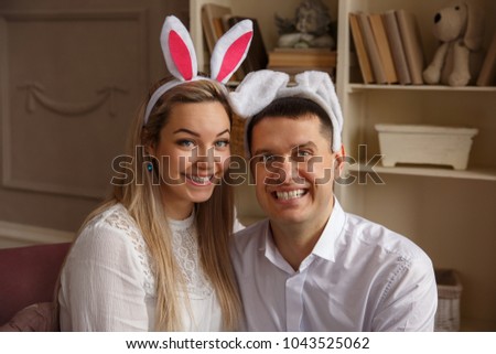 Funny couple wearing bunny ears and smiling at Easter day. Crazy emotions at Easter sunday