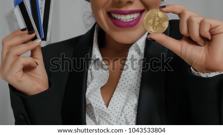 Credit cards and Bitcoin in the hands. Business Lady shows the possibilities of crypto currency. Internet Trade and Mining