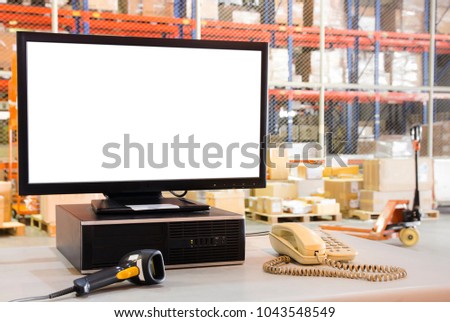 Computer with blank screen in warehouse factory.