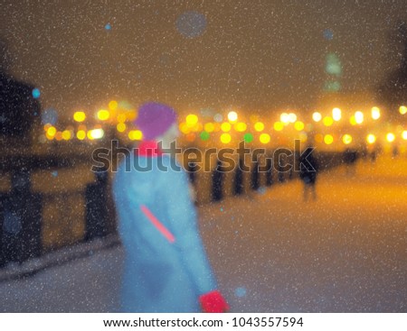 Blurred picture of park at the snowfall with lights