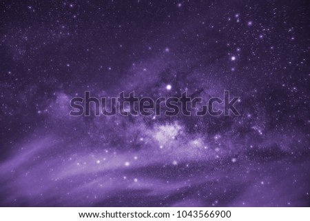 Ultra violet tone, Milky way galaxy with stars and space dust in the universe, long speed exposure, Tone purple trend. Royalty-Free Stock Photo #1043566900