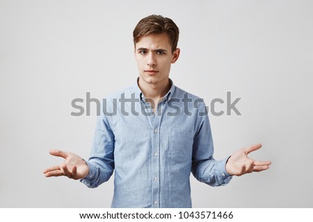 Portrait of handsome boy who looks uncertain. Boy dressed up to go to the bar with girl he met in social network but she did not show up. Why she did not come. Question botheres our hopeless romantic Royalty-Free Stock Photo #1043571466