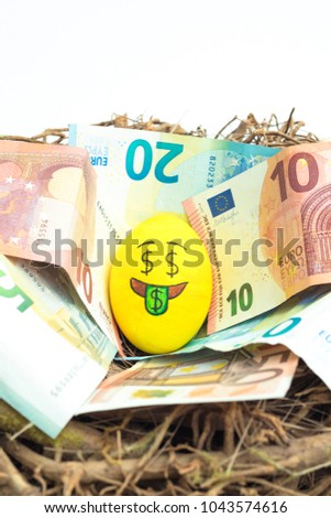 Easter egg with facial expression "I love money" placed on euro paper money.