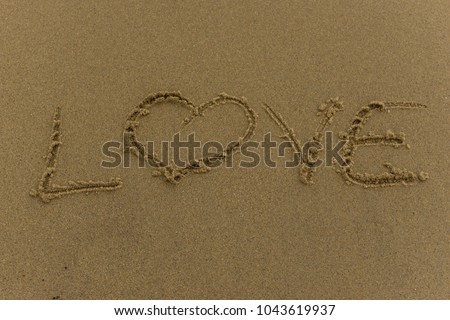 Sand photo written words and numbers on the beach with waves