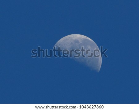moon in the fourth quarter waning in the southern hemisphere reflecting the light of the sun under a sky of intense blue, sao paulo, brazil
