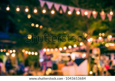 Abstract Blurred image of Night  Festival in garden with bokeh for background usage. (vintage tone) Royalty-Free Stock Photo #1043653684