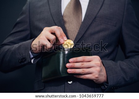 Close-up of businessman with wallet receiving and paying by bitcoin or cryptocurrency - crypto currency is the future of digital cashless financial banking trade