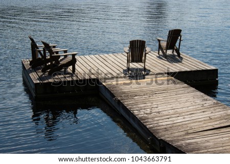 Beautiful dock on the Lake with Muskoka chairs in beautiful Algonquin Park just out side of Huntsville, located in Muskoka just outside of Toronto. 