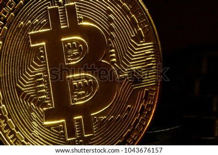 Bitcoin coin stay on black keyboard near enter button