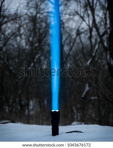 Luminous flash light beam in the snow