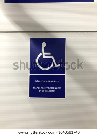 the Thai word said "Please assist the disability".  Sign to support the person in needed.