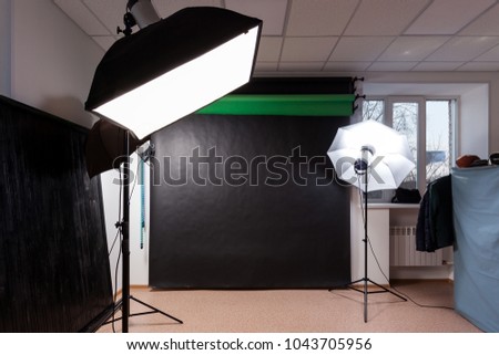 Photostudio with studio equipment: black, green, white background for photography, studio flashes, deflectors, Octoboxes