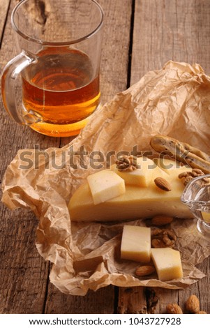 Gruyère cheese with beer on a wooden table
