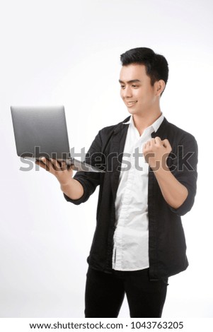 Asian young man student smile and use laptop