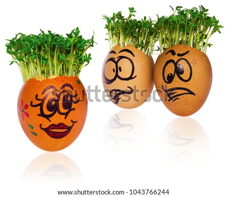 Handpainted Easter eggs in funny scared and surprised cartoonish faces with cress like hair. Handmade multicolored eggs look at the outstanding foreign individual egg.