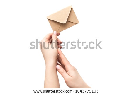 Female hand holds an vintage old envelope isolated on a white background