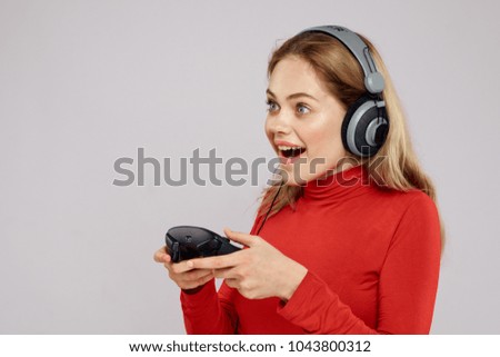 woman with a joystick and in headphones, game                               