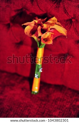 Wedding bridal bouquet in the hands of bride before wedding ceremony with decoration a lot of flowers and colorful tape shot taken by selective soft focus and macro