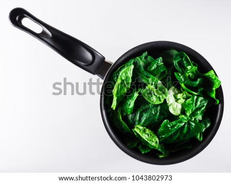 Stock pot with fresh green spinach.