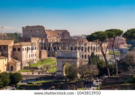 Titus Arch and the Roman Colosseum in Rome, Italy as seen from the Palatine Hill