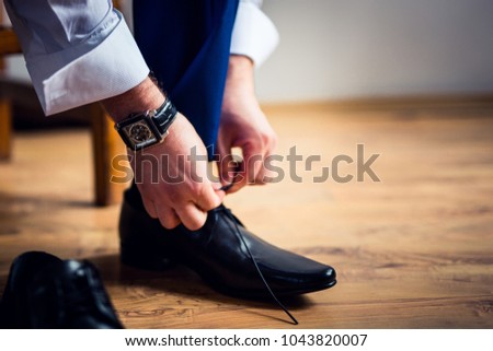 A businessman wears shoes. Royalty-Free Stock Photo #1043820007