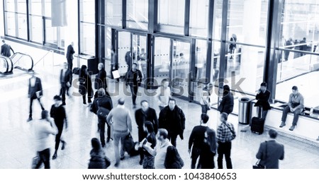large crowd of blurred business people rushing at a airport