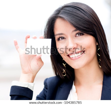 Friendly woman holding a business card and smiling