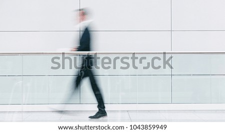 blurred businessman walking in a floor