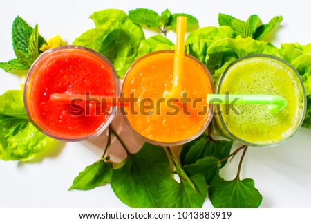 Healthy tomato, avocado and carrot smoothie in a glass isolated on white background