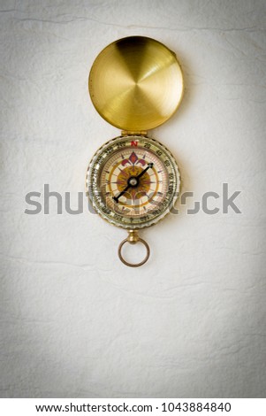 Vintage compass on white handmade paper