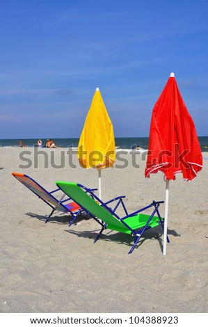 Two beach chairs and umbrellas on the beach