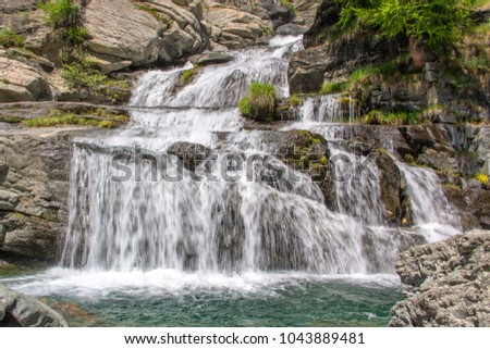 Lillaz waterfalls near Cogne, Gran Paradiso national park, Aosta Valley in the Alps, Italy Royalty-Free Stock Photo #1043889481