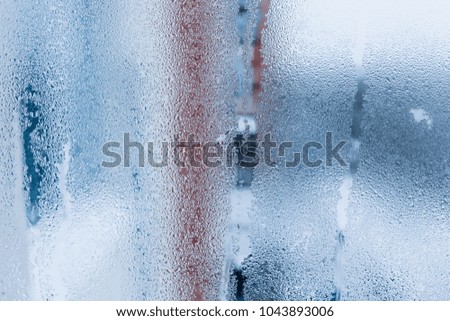 Background of natural water condensation, window glass with high air humidity, large drops drip. Collecting and streaming down