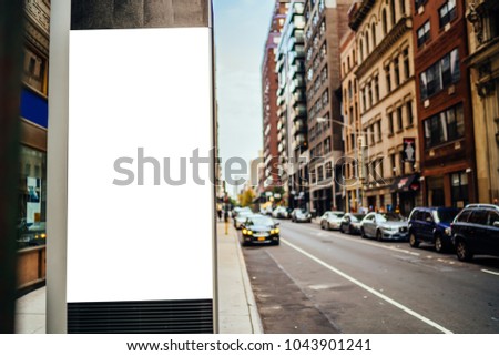Clear empty billboard with copy space area for advertising text message or content, public information board in urban scene, street Lightbox with city scene on background, promotional sale mock up