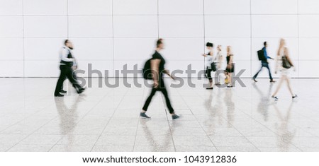people walking in a modern hall