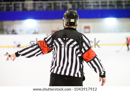 Referee is judging a match on ice hockey
