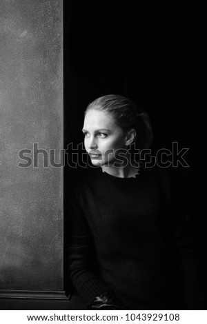 Young model girl portrait. Fashionable elegant stylish woman face expressions. Beautiful blonde with kind lovely eyes posing for camera. Silhoutte of babe isolated on black. Emotions, state of mind