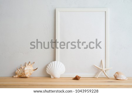 Summer beach holiday vacation concept, photo frame and seashell decoration mockup with white wall background