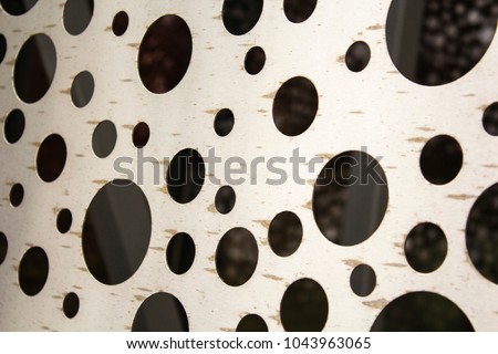 bright metal surface with round holes. abstract background