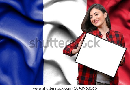 Woman holding blank board against national flag of France