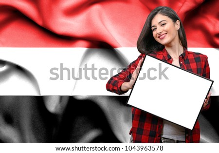 Woman holding blank board against national flag of Yemen
