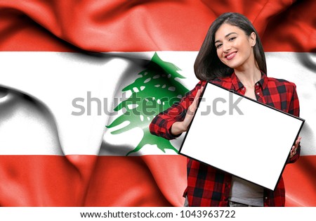 Woman holding blank board against national flag of Lebanon