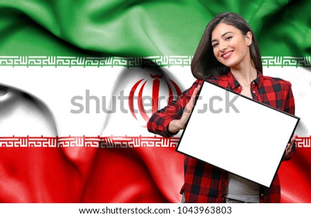 Woman holding blank board against national flag of Iran